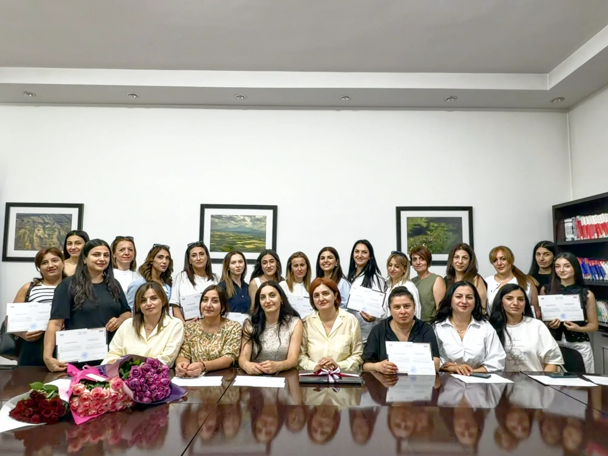 Digital Literacy graduates with their certificates around a conference table in Yerevan, Armenia